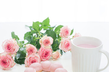cup of drink with pink roses