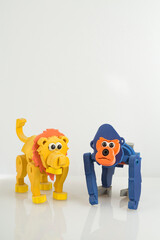 monkey and toy lion, on white background, close up image