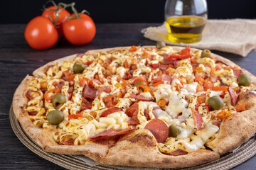 pizza covered with tomato sauce, catupiry cheese, sliced pepperoni, diced tomato and chili pepper