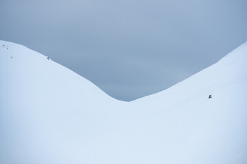 snowy mountain with contrasting sky and detail on the slope