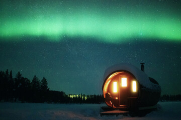Surreal sauna session below northern lights. Taken in Swedish Lapland.