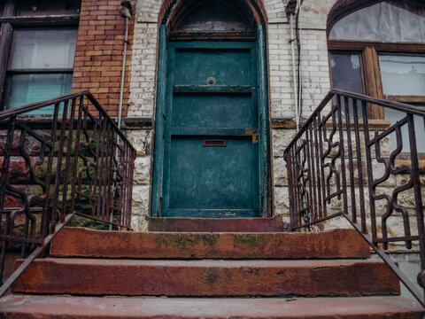Dark green apartment door and stoop in Manhattan, New York