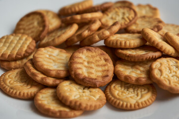 Plenty of round small baked cookies close up