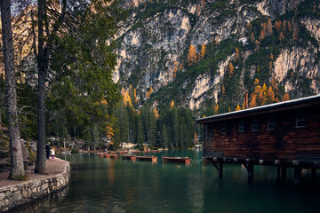 Fototapeta na wymiar The beautiful Braies lake in late autumn with a little snow, Pearl of the Dolomite lakes is an UNESCO heritage and is located in the Braies Alto Adige,Italy