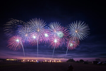 a crowd of people came to the festival, a festival of fireworks, explosions of pyrotechnic charges, volleys of salutes against the backdrop of happy people rejoicing in the beautiful spectacle, multic