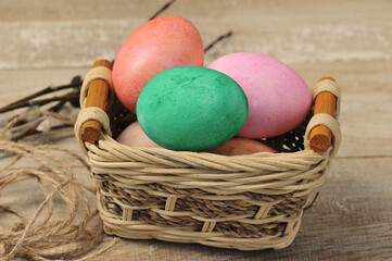 painted easter eggs in a wicker basket