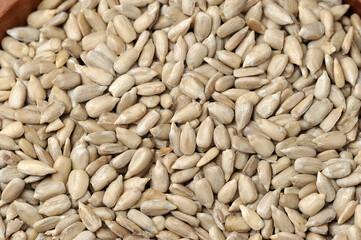 peeled sunflower seeds in a wooden bowl