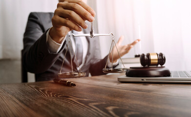 Business and lawyers discussing contract papers with brass scale on desk in office. Law, legal services, advice, justice and law concept
