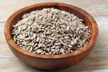 peeled sunflower seeds in a wooden bowl