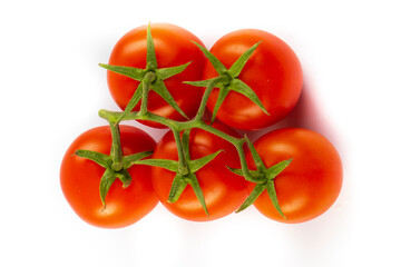 Fresh cherry tomatoes with a sprig isolated on a white background. Tomato branch. Fresh tomatoes with green leaves.