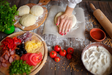 woman kneads the dough with hands while cooking