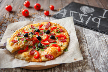 Woman holding piece of pizza