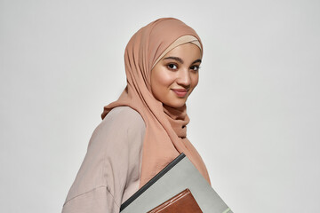 Smiling young arabic businesswoman in hijab with notepad