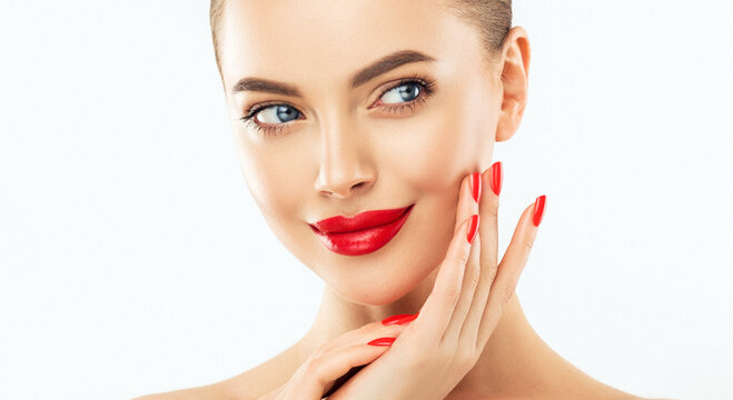 Beautiful woman showing red  manicure nails . Makeup, beauty and cosmetics. Famele beauty face care and treatment. Expressive facial expressions