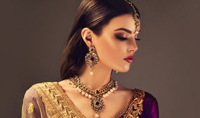 Portrait of beautiful indian girl. Young India woman model with kundan jewelry set. Traditional...