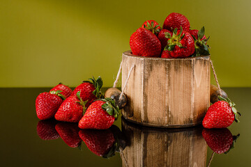 strawberries in a wooden barrel. It can be used in advertising products. Different background color