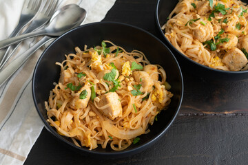 Bowls of  Chicken Pad Thai: Bowls of chicken pad Thai garnished with cilantro and peanuts