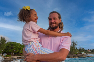 A Caucasian father and mixed race daughter having a day to remember at the beach together