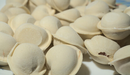 Raw frozen dumplings. Closeup. Side view