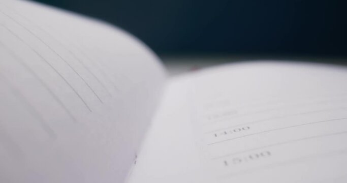 detailed extreme close-up spread of a notebook with a red bookmark.