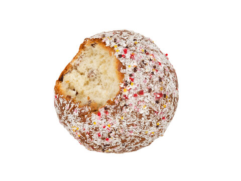 Nibbled, tasted traditional Orthodox cake with white icing and multicolored sugar sprinkles isolated on a white background. Design concept for a happy Christian Easter.