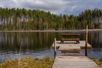 There are wooden boardwalks with benches and rubbish bins by the lake