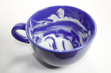 Blue mug with yogurt in the background