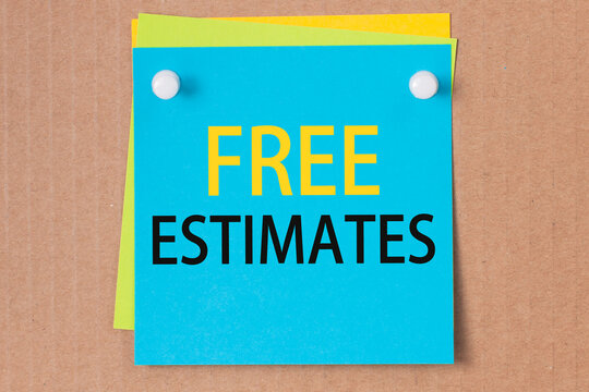 on a paperboard background - a light blue square sticker with the text free estimates, business concept