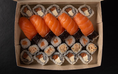 Sushi, sushi delivery box in Brazil, black background, selective focus.