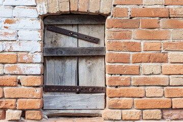 boarded-up window against the red brick wall, place under the text