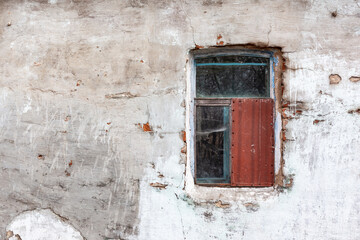 window in an abandoned house, an old concrete wall, an extinction village