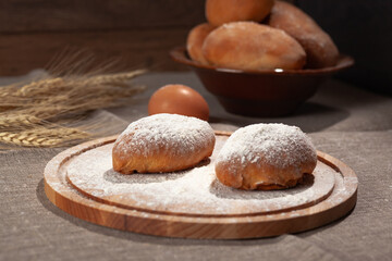 round cutting board in flour with two pies