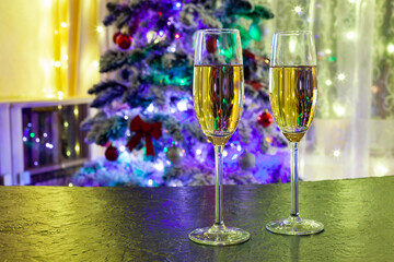 two glasses of champagne against the backdrop of the Christmas tree