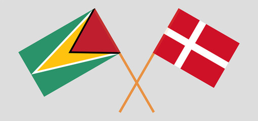 Crossed flags of Guyana and Denmark. Official colors. Correct proportion