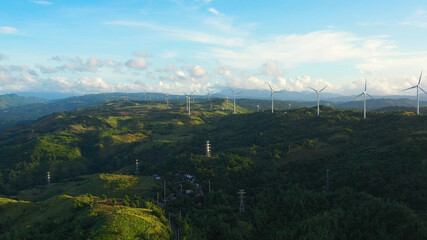 Windm ills and a wind farm on the hillsides. Philippines, Luzon. Wind turbines in the mountains.