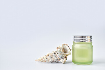 Glass jar with cream, serum and shell. Eco-friendly organic natural cosmetics for skin and body care. Copy space