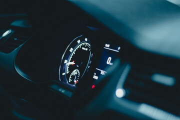 Interior car with analog speedometer at. night