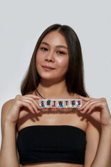 Portrait of asian woman holding weekly pill organizer