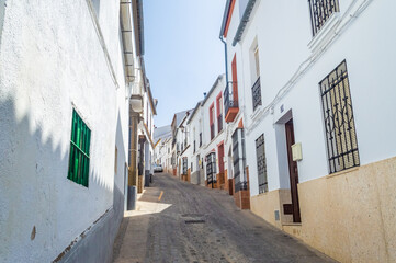 Fototapeta na wymiar OLVERA, SPAIN, 24 JULY 2016: White street of Olvera, one of the Pueblos Blancos in Andalusia