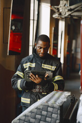 Portrait of a firefighter standing in front of a fire engine