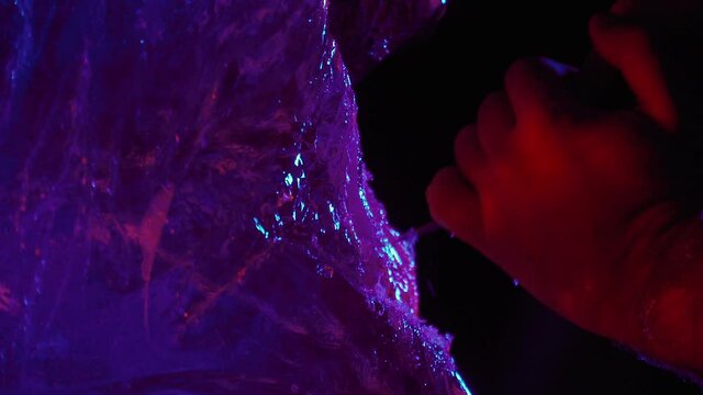 Close up of a hand of an artist working with a chisel on an ice sculpture, 4k