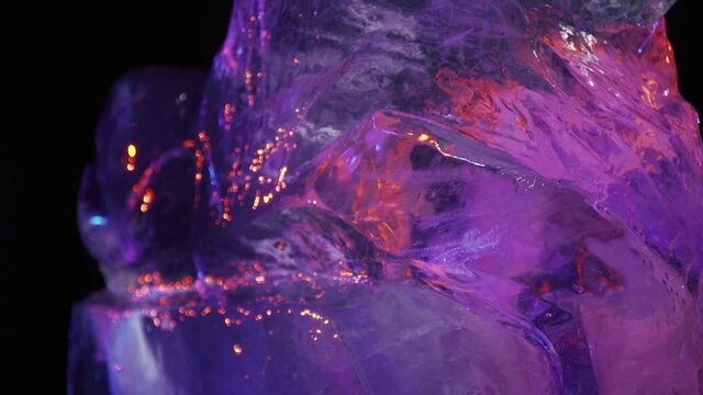 Ice statue of a lion on starting stages of ice carving, purple light, studio, 4k