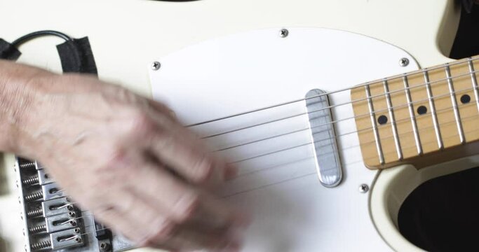 Musician plays tele - type electric guitar, close-up, real people