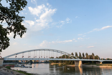 Belvarosi Hid bridge, also known as Downtown bridge on the tisza river during a sunny sunset. The bridge connects the two parts of this city, the main one of Southern Hungary.