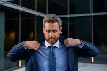 Fototapeta premium Businessman standing in city is happy to succeed in his work. Business man winner.