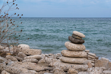 A group of inukshuks overlook Lake Ontario in Colonel Samuel Smith Park in Toronto in the later evening