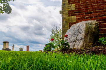 A low shot of the corner of Salem United Church and the adjacent cemetery in Pickering, Ontario, on an overcast day.