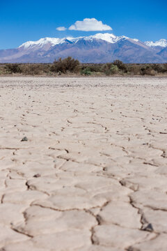 A dry lake called pampa el leoncito or barreal blanco, with the Andes mountains in the background.. This touristic landmark is located in San Juan, Cuyo, Argentina.