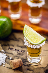glass of gold tequila with old mexico map in the background