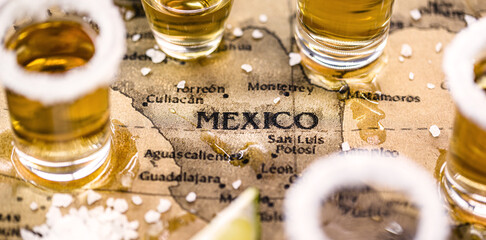 old mexico map with tequila glasses around, selective focus, image in celebration of tequila day